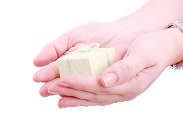 Image showing Female hands giving a gift. Isolated on white 