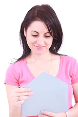 Image showing Young beautiful woman opening a letter isolated on a white background