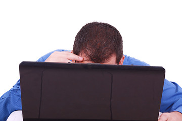 Image showing A bald man hiding behind his laptop computer screen. 