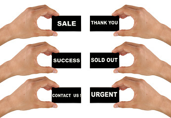 Image showing black business card in hand with text