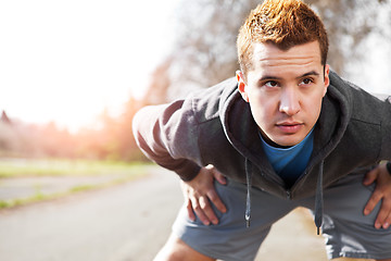 Image showing Mixed race man stretching