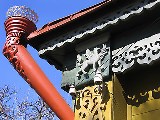 Image showing fragment of a old Russian house with decorative carvings and rai