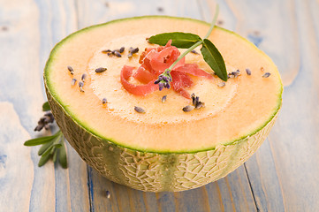 Image showing fresh melon soup with parma ham and lavender flower