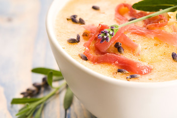 Image showing fresh melon soup with parma ham and lavender flower