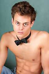 Image showing Shirtless young man with bow tie
