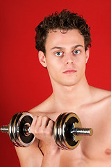 Image showing Young man training with dumbbell