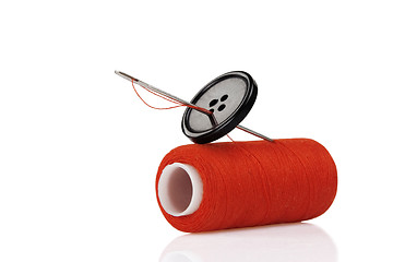 Image showing red spool, black button and needle