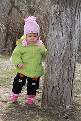 Image showing girl hides behind a tree