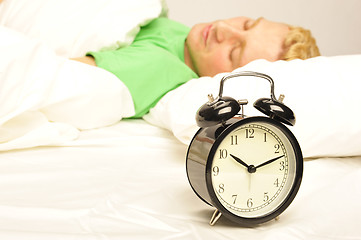 Image showing Serene man lying on his bed before being woken up   