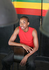 Image showing Young man sitting on a chair