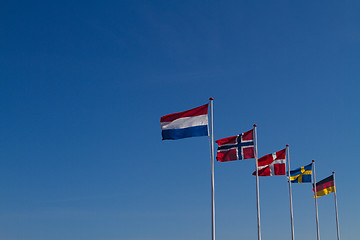 Image showing Flags on a blue sky