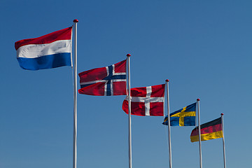 Image showing Flags on a blue sky