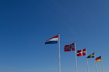 Image showing Flags on a blue sky