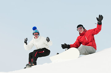 Image showing Happy sportsman with snowboards