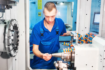 Image showing worker operating CNC machine center