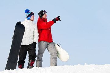 Image showing Happy sportsman with snowboards