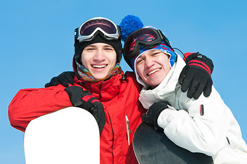 Image showing Happy sportsman with snowboards