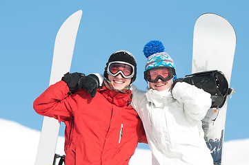 Image showing Happy sportsman with snowboards