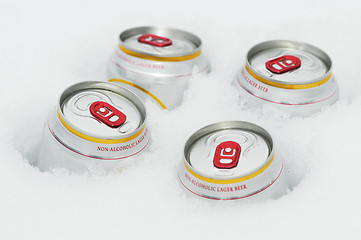 Image showing beer cans in winter snow