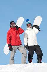 Image showing Happy sportsman with snowboards