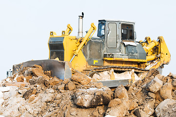 Image showing bulldozer loader at winter frozen soil excavation works
