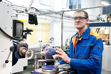 Image showing worker at machine tool operating