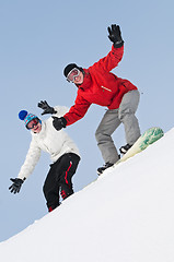 Image showing Happy sportsman with snowboards