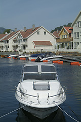 Image showing Day-cruiser and water-front houses