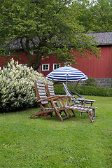 Image showing Teak chairs in the garden