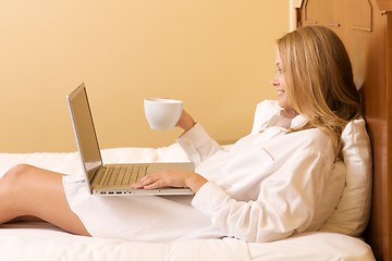 Image showing Happy Girl in Bed Using a Laptop Computer