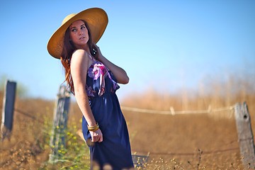 Image showing Young Beautiful Woman on a Field in Summer Time