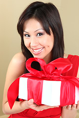 Image showing Asian Woman Holding a Gift Package Wrapped With Ribbon