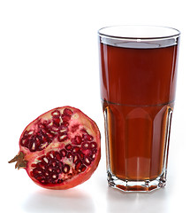 Image showing Half of pomegranate fruit and glass with juice