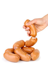 Image showing Hand taking sausage isolated on the white background