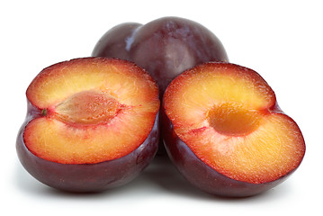 Image showing Violet plums: whole and two halves