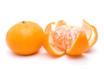 Image showing Whole and peeled tangerines