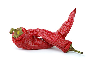 Image showing Two dried red chili peppers isolated on the white background