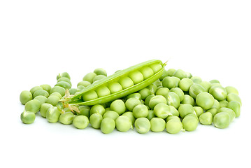 Image showing Cracked pod over pile of green peas
