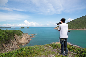 Image showing photographer takes a photo of the landscape 
