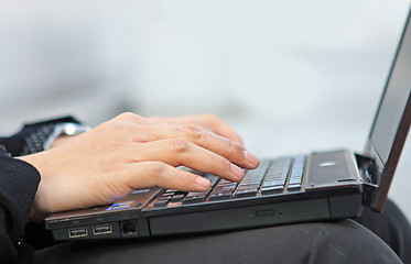 Image showing Hands typing on laptop computer keyboard close up