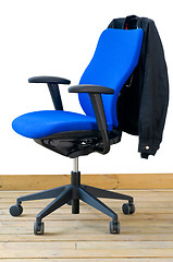 Image showing modern blue office chair with jacket on back