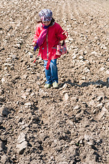 Image showing Cute child girl with ice cream playing in the field