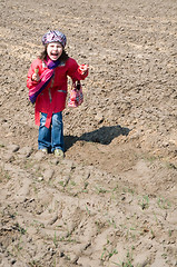 Image showing Cute child girl with ice cream playing in the field