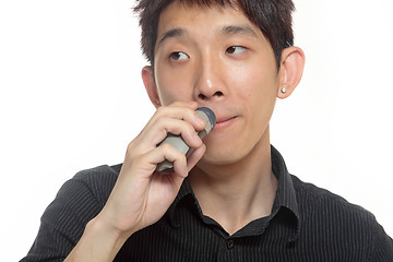 Image showing young man shaving his beard off with an electric shaver 