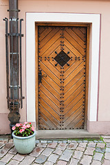 Image showing Old door and vase with flowers