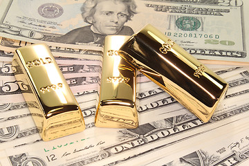 Image showing three gold bars on dollar bills
