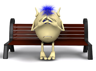 Image showing Haired shamed puppet sitting on brown park bench