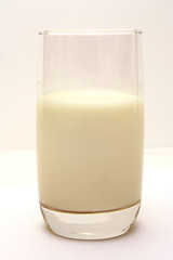 Image showing Glass with milk on smooth white table