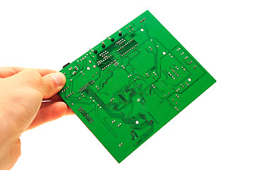 Image showing Human hand holding green computer circuit board