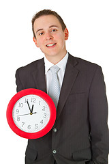 Image showing Young businessman holding a clock